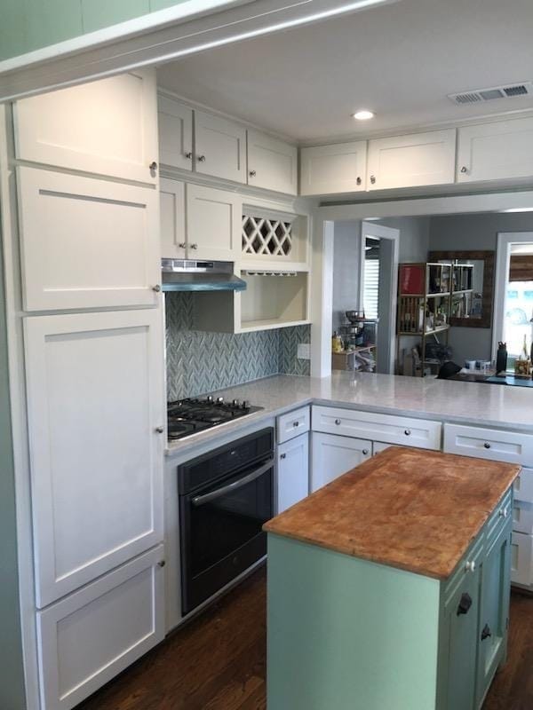 Two-tone white and green kitchen cabinets sprayed in a Fort Bend County home