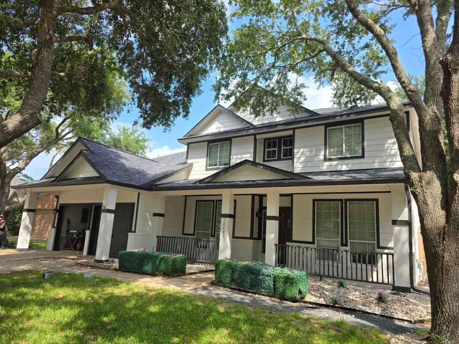Freshly painted two-story home with white siding and black trim in Sugar Land, TX