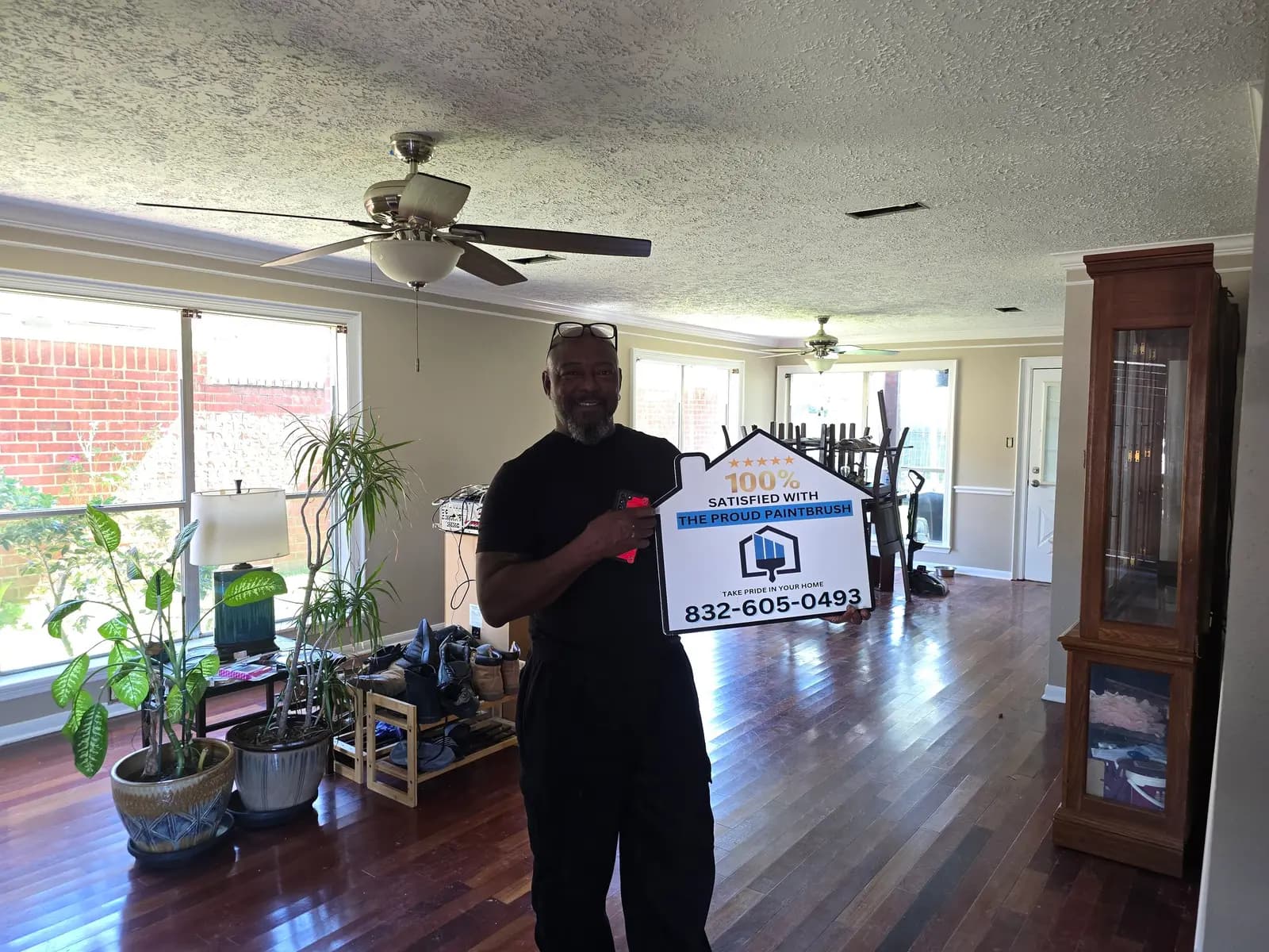 Exterior painting customer in Missouri City TX standing in front of freshly painted home
