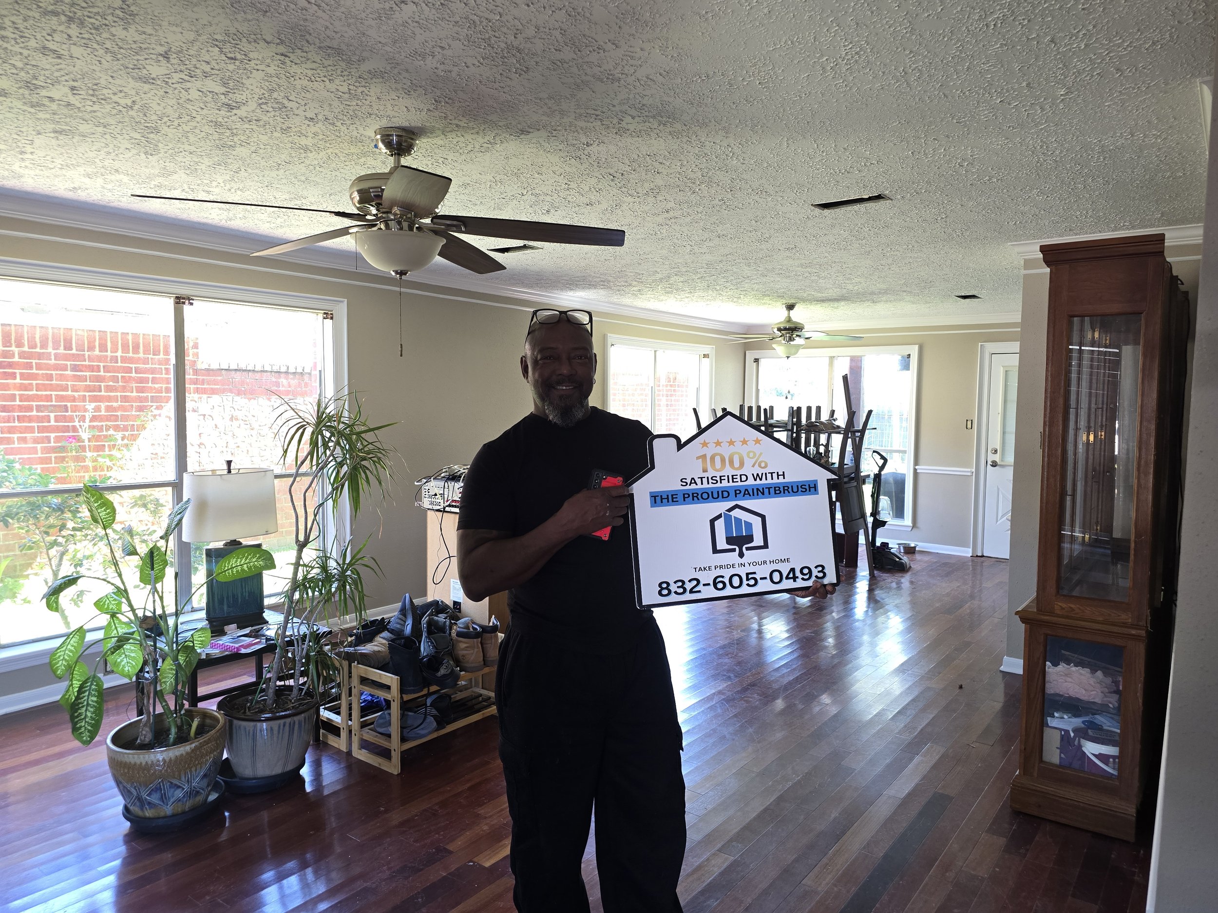 Exterior painting customer in Missouri City TX standing in front of freshly painted home