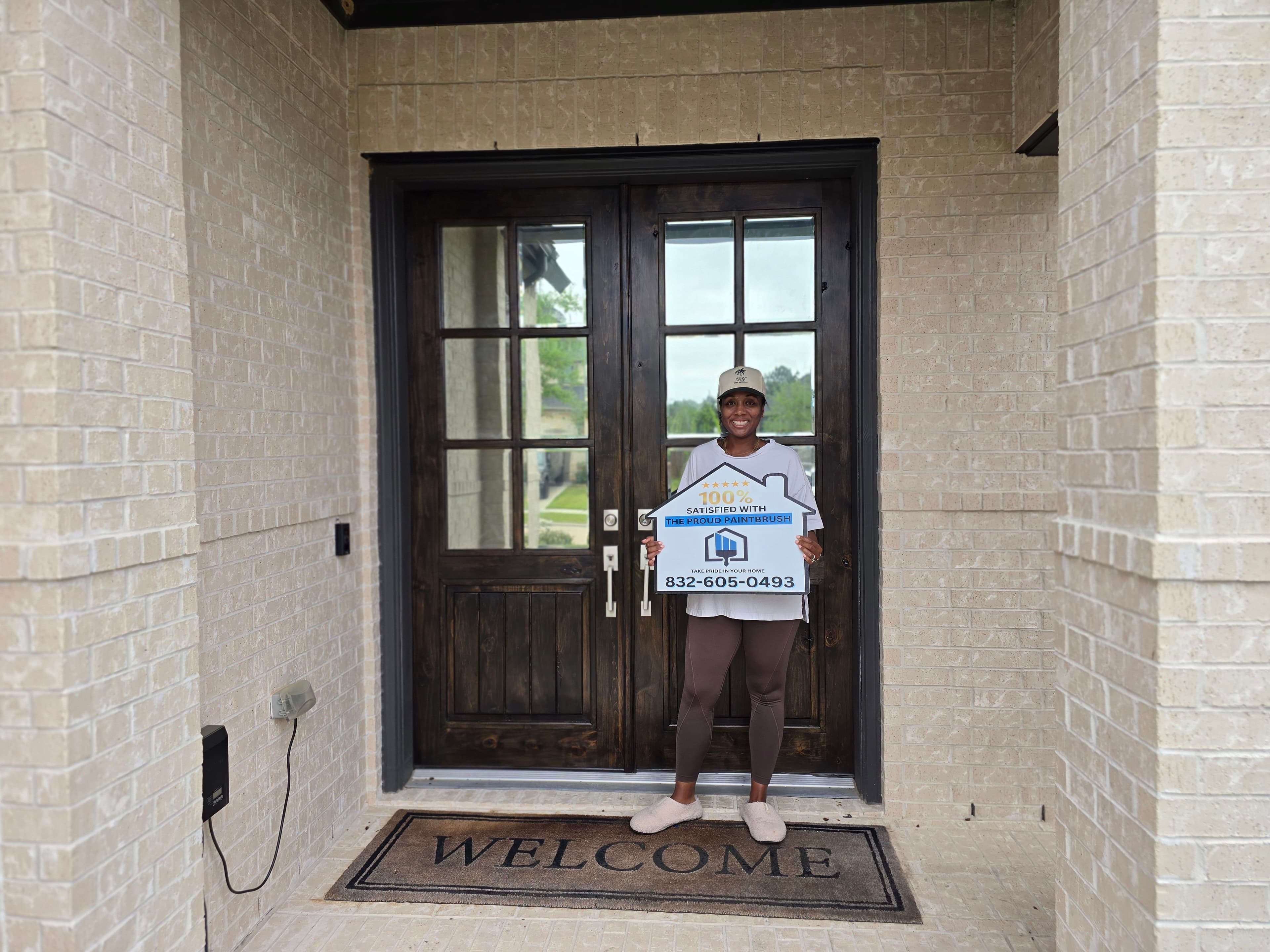 Fulshear TX exterior painting customer holding 100% satisfied sign