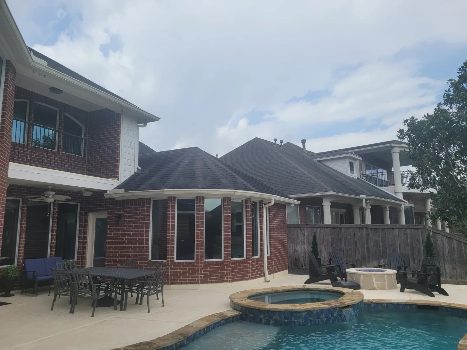 Brick home exterior with backyard pool patio in West Houston, TX by The Proud Paintbrush