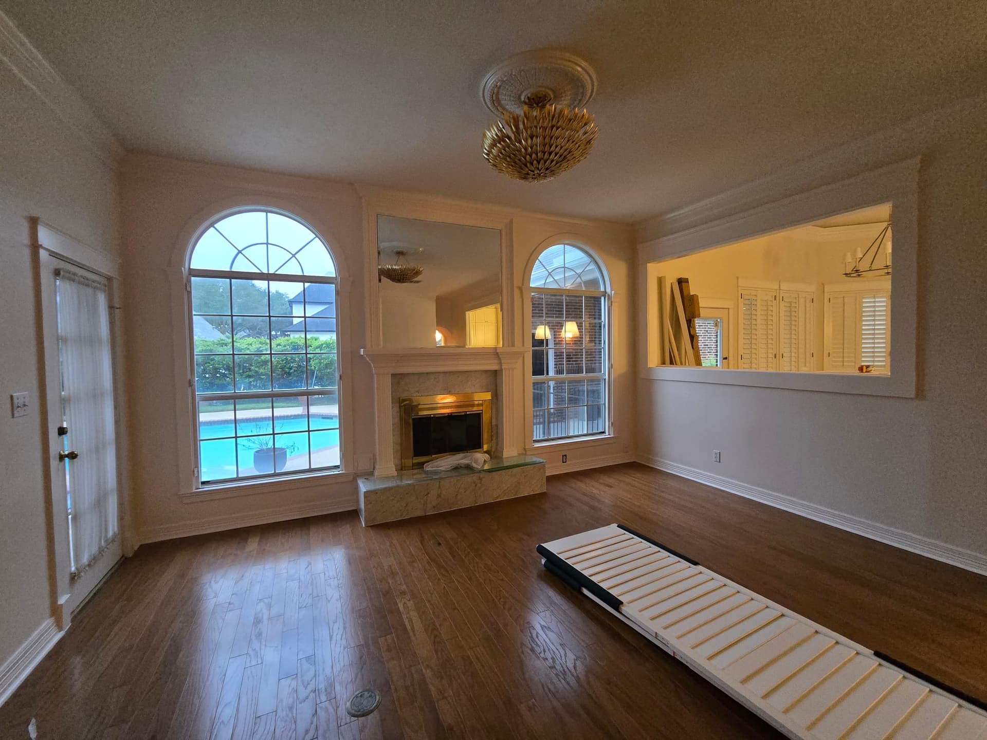 Cream living room with fireplace repainted in a Katy, TX home by The Proud Paintbrush