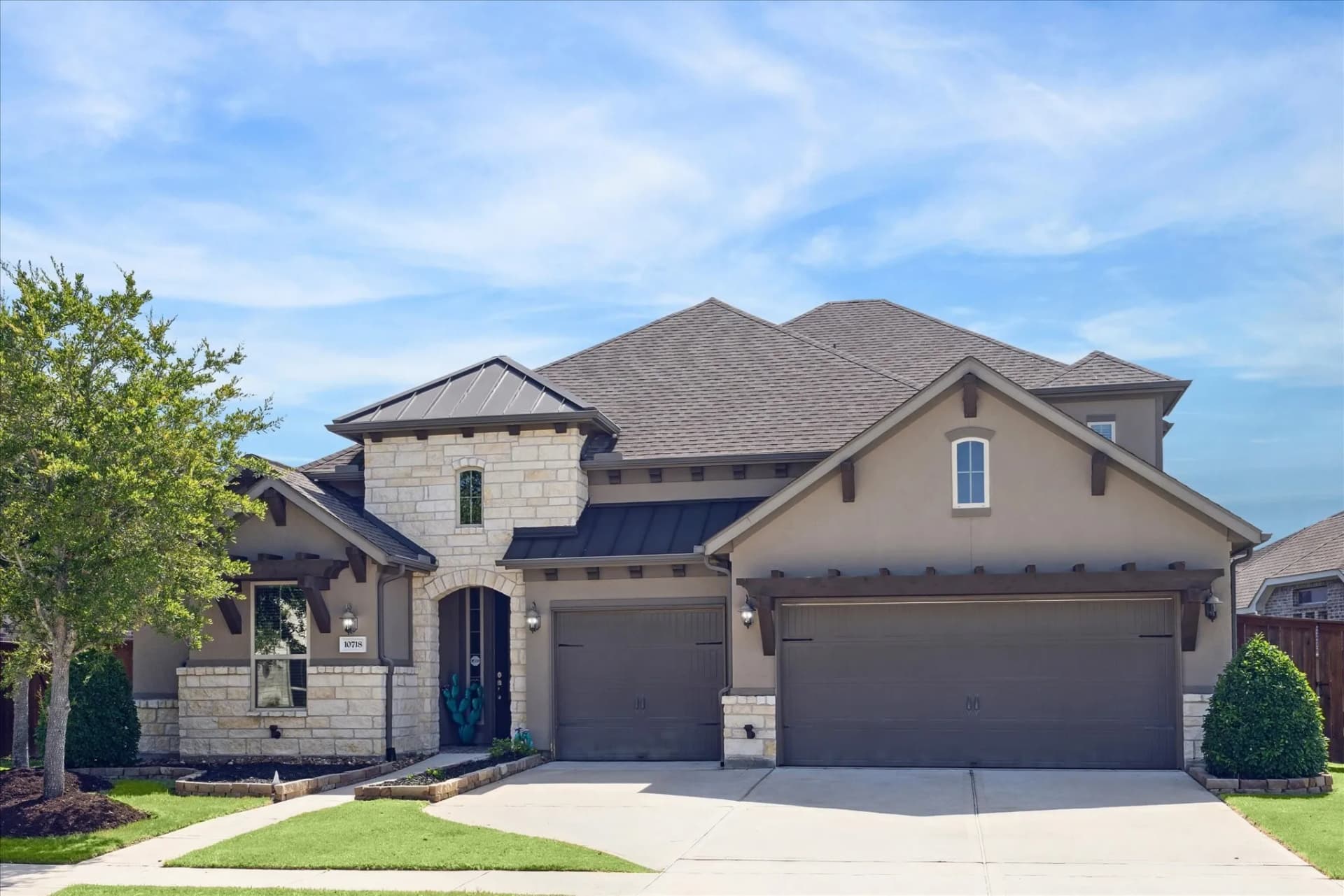 Stucco and stone home exterior repainted in Missouri City, TX by The Proud Paintbrush