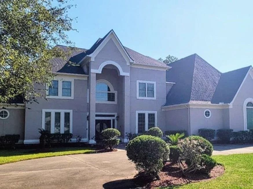 Tan stucco luxury home exterior repainted in West Houston, TX by The Proud Paintbrush