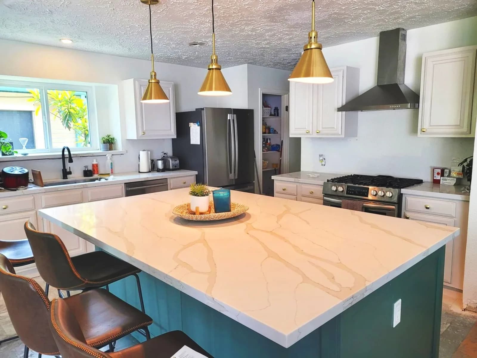Bright kitchen with white cabinets and marble island painted in Sugar Land, TX by The Proud Paintbrush