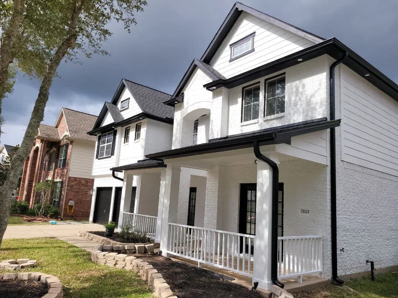 White modern farmhouse exterior freshly painted in Sugar Land, TX by The Proud Paintbrush