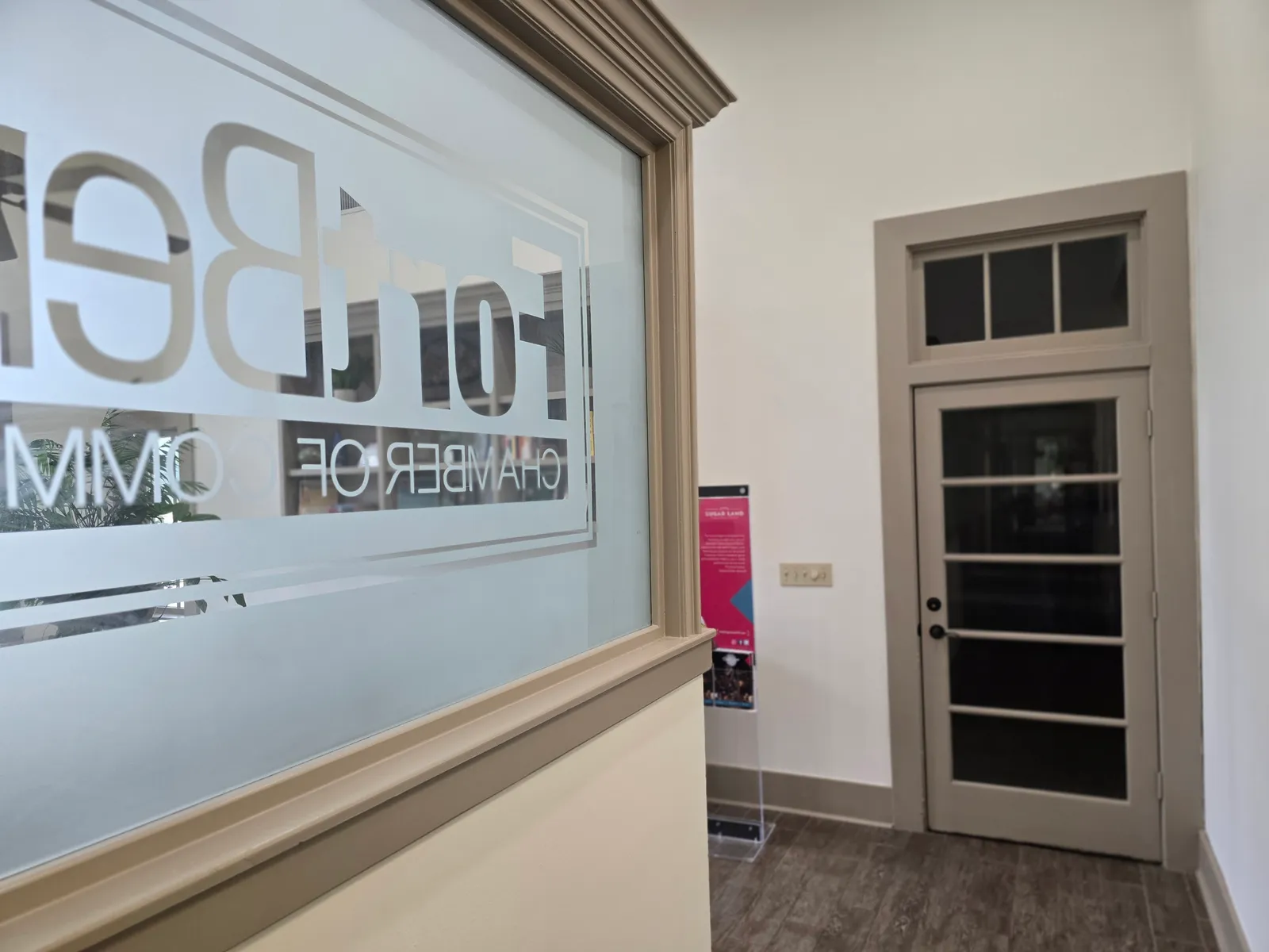Commercial hallway with glass partitions repainted by The Proud Paintbrush