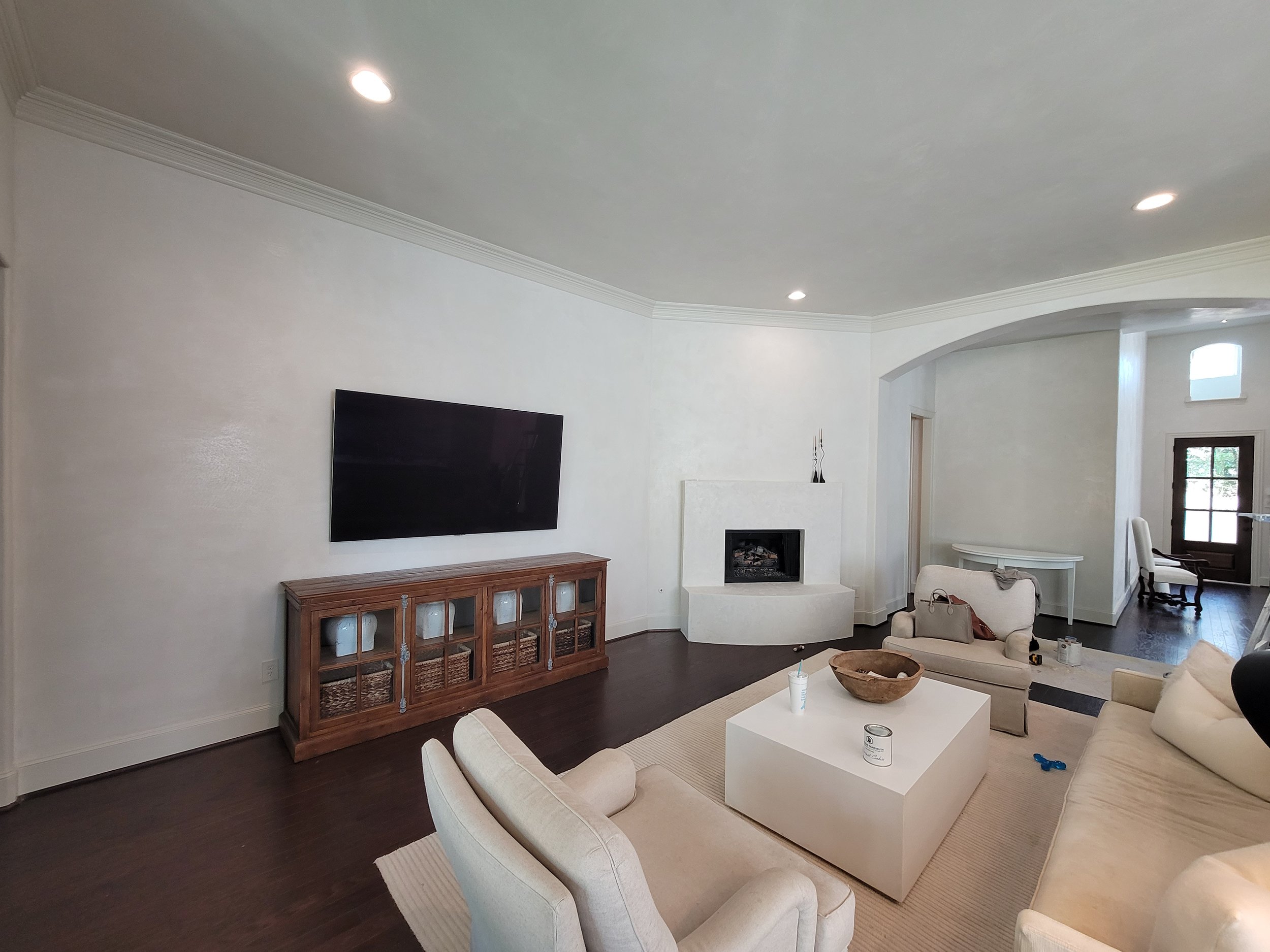 Bright, freshly painted living room with crisp white walls and a modern fireplace in Missouri City, TX