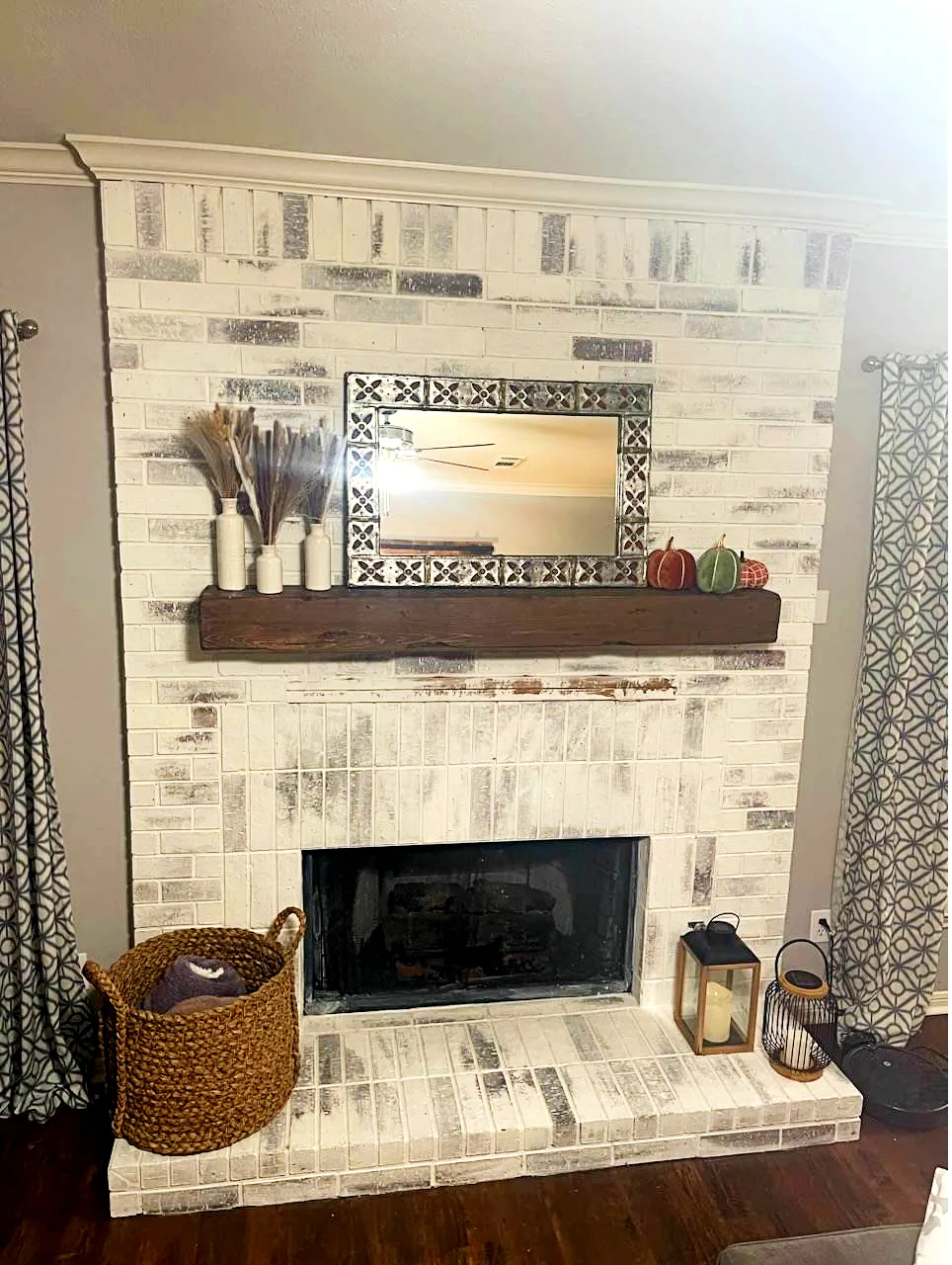 limewashed brick fireplace that has been decorated for fall