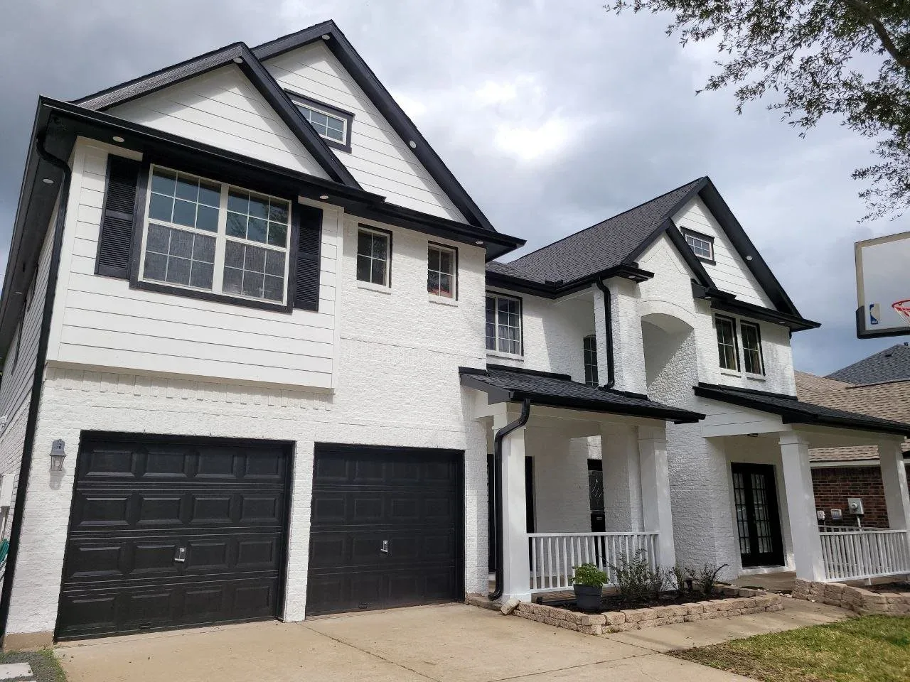 Freshly painted black and white brick and Hardie board exterior on a home in Missouri City, Texas