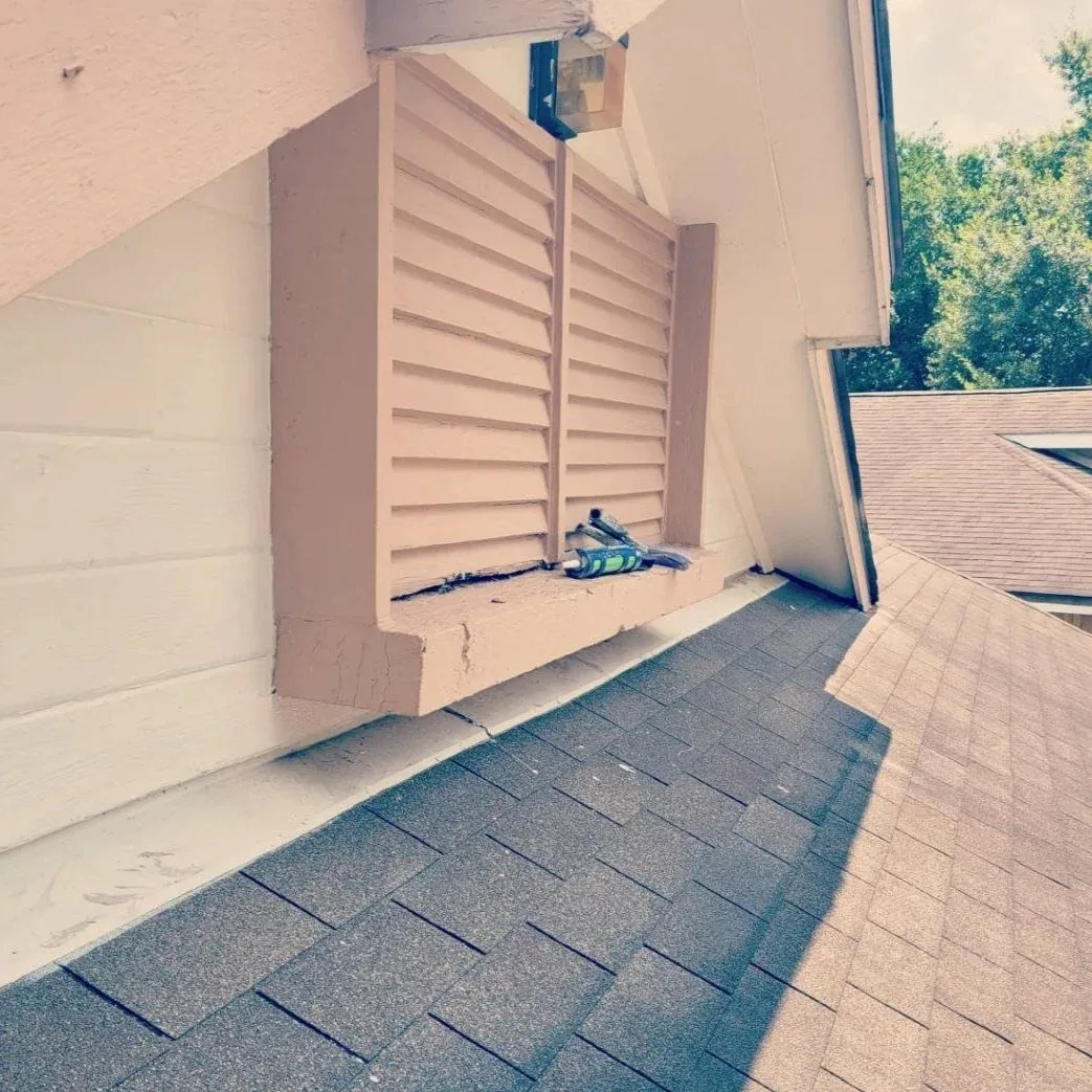 upper part of house getting caulked and painted