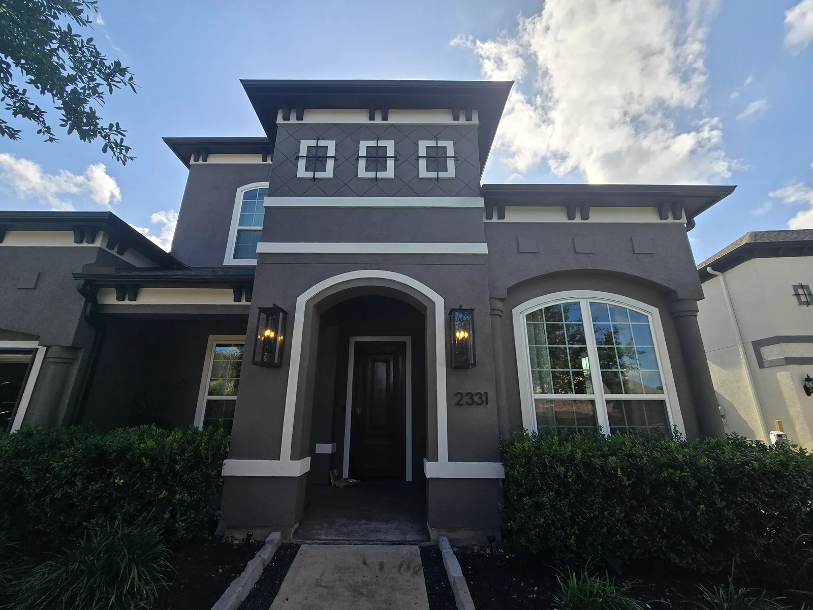 Front entry exterior stucco repaint in Missouri City, TX, painted a unified charcoal by The Proud Paintbrush