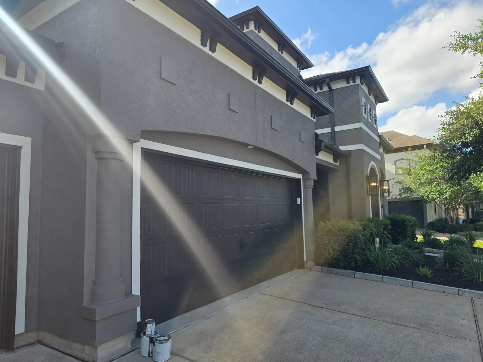 Garage exterior stucco repaint in Missouri City, TX, painted charcoal by The Proud Paintbrush
