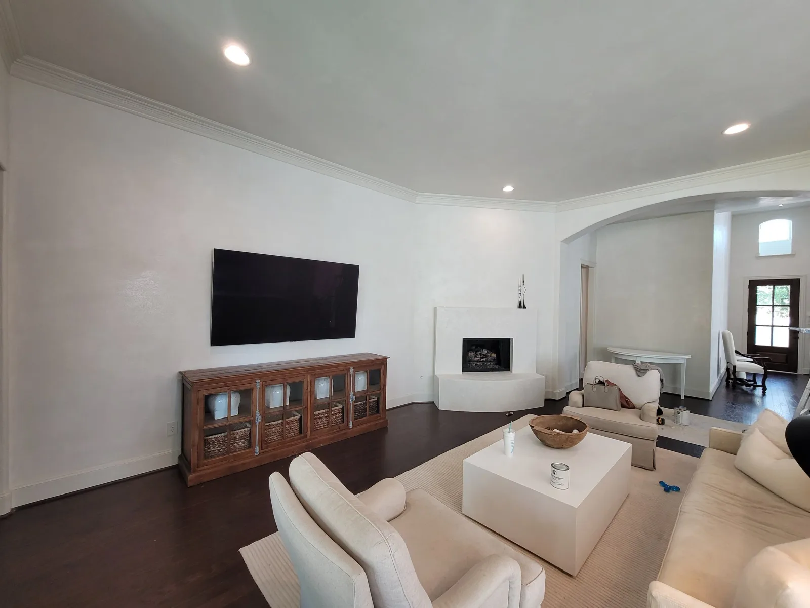 Interior painting cost estimate in Missouri City, TX — freshly painted living room with fireplace, crown molding, and trim