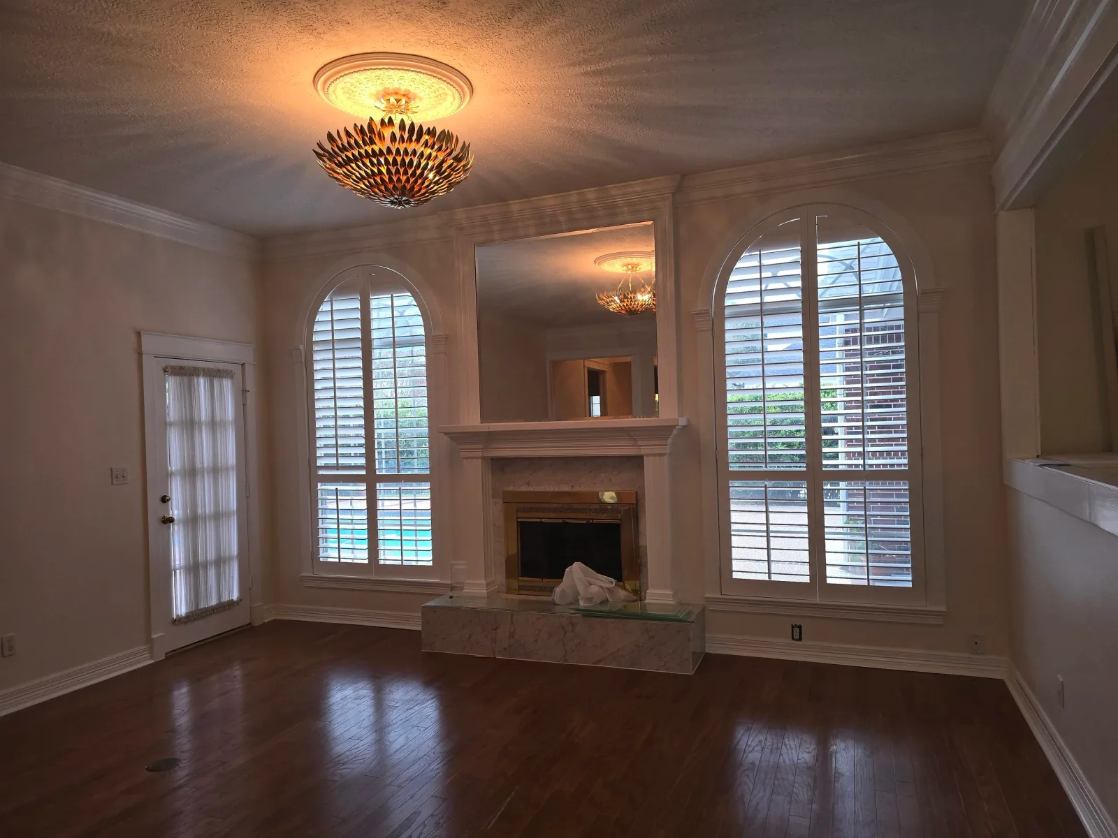 Interior painting cost estimate in Missouri City, TX — repainted formal living room with arched windows in an upscale Missouri City home