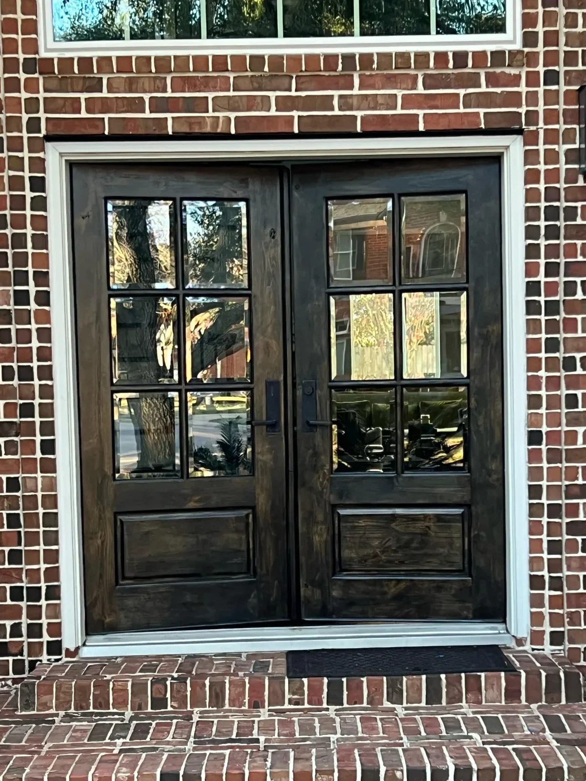 Richly stained wood double front door after refinishing in Missouri City, TX by The Proud Paintbrush