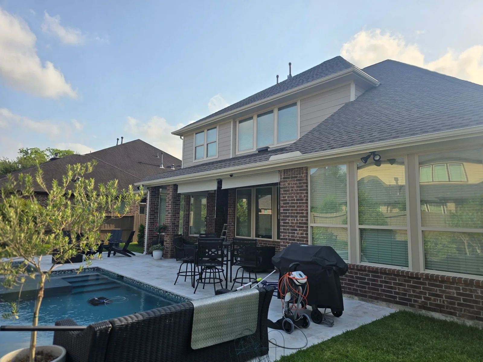 Exterior house painting project in Missouri City showing freshly painted siding and outdoor living area