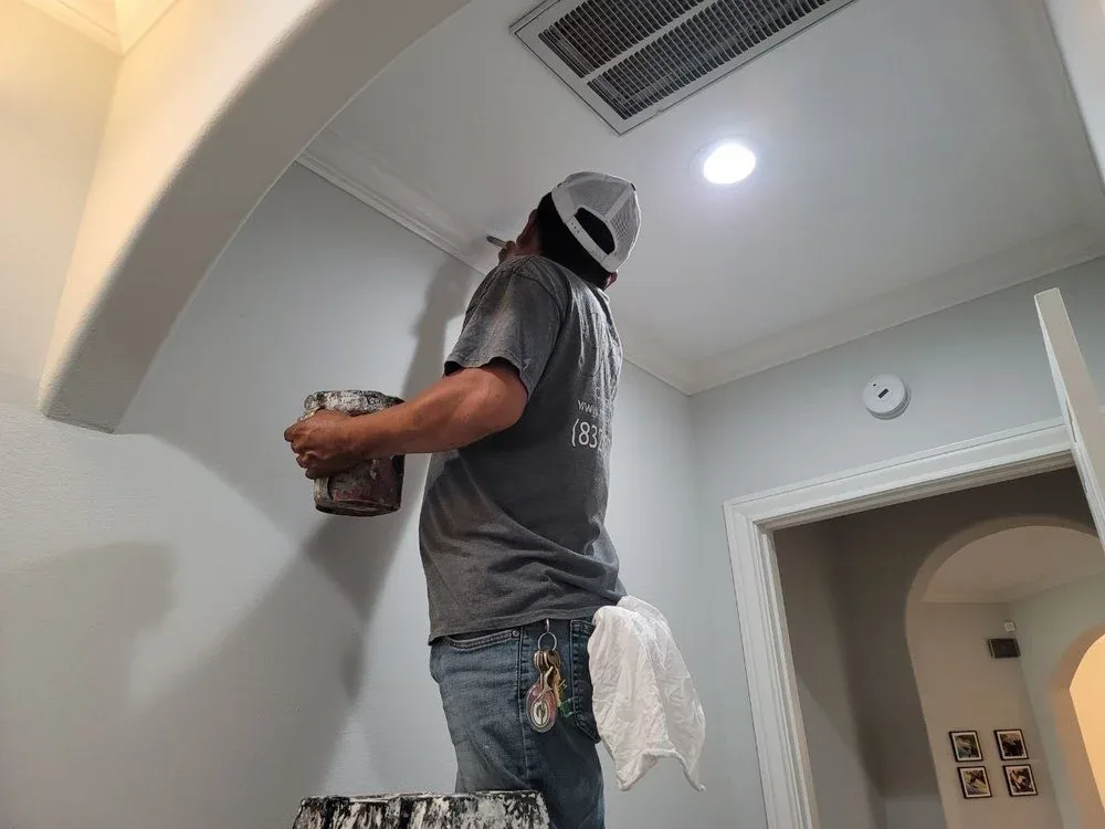 Painter cutting in interior walls for sharp finish in Sugar Land by The Proud Paintbrush