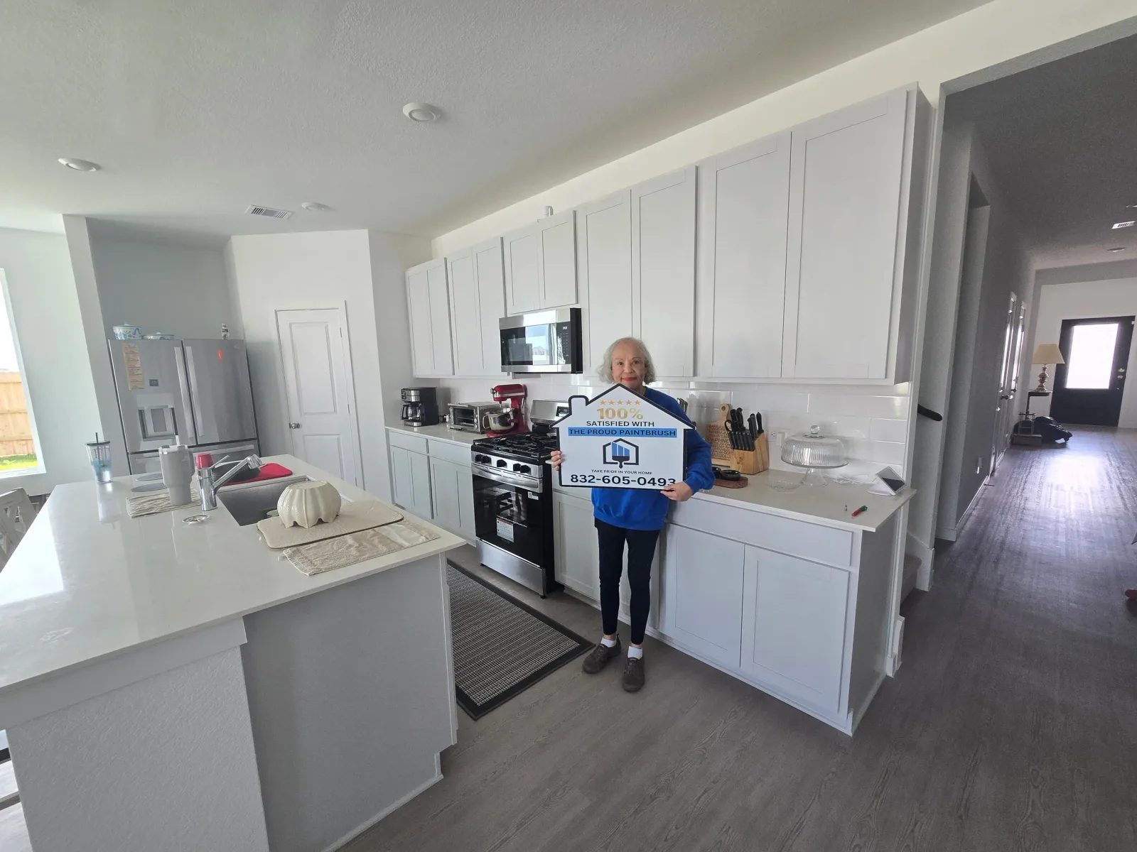 Happy homeowner after kitchen painting project completion in Missouri City, TX by The Proud Paintbrush.