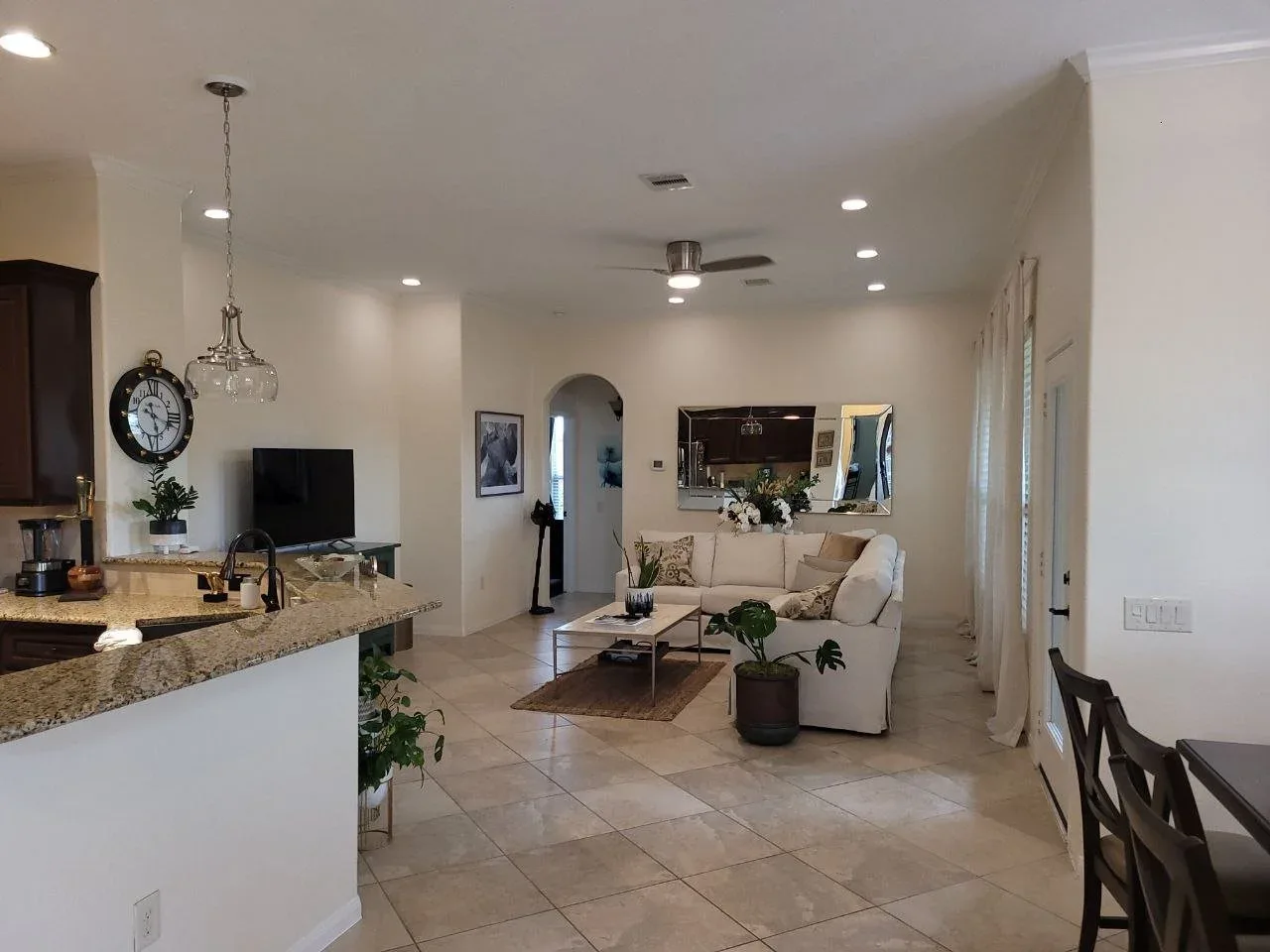 Freshly painted off-white living room and kitchen interior in Katy, Texas by professional house painters.