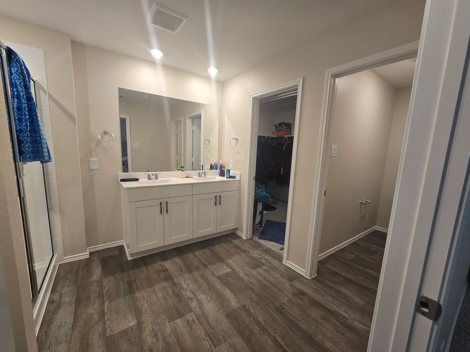Primary bathroom with builder-grade white walls and trim in a Fulshear, TX home before whole-home interior painting