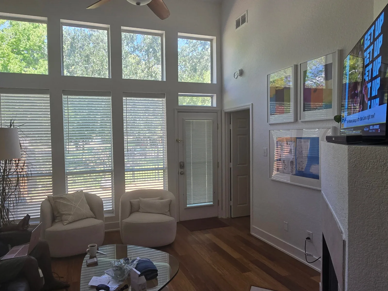 Open-concept living room with tall windows and freshly painted walls in Rosenberg, TX interior painting project by The Proud Paintbrush.