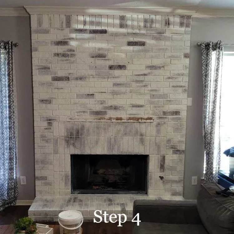 limewashed brick fireplace that has been distressed