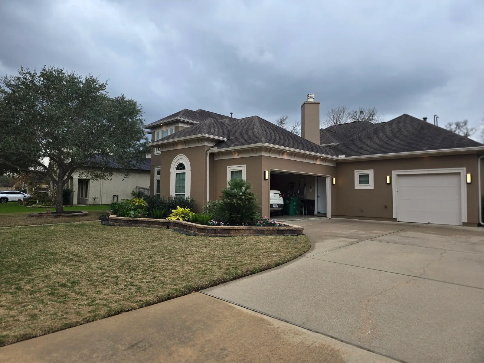Freshly painted stucco exterior with brown body and white trim in Sugar Land, Texas