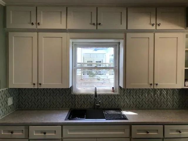 Freshly painted kitchen cabinets with modern finish in Sugar Land, TX cabinet painting project by The Proud Paintbrush.