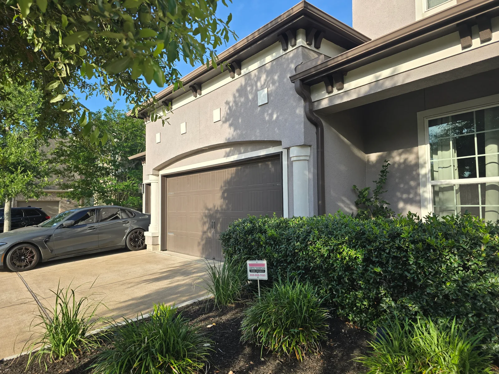 Faded tan stucco garage exterior before repaint, Missouri City, TX