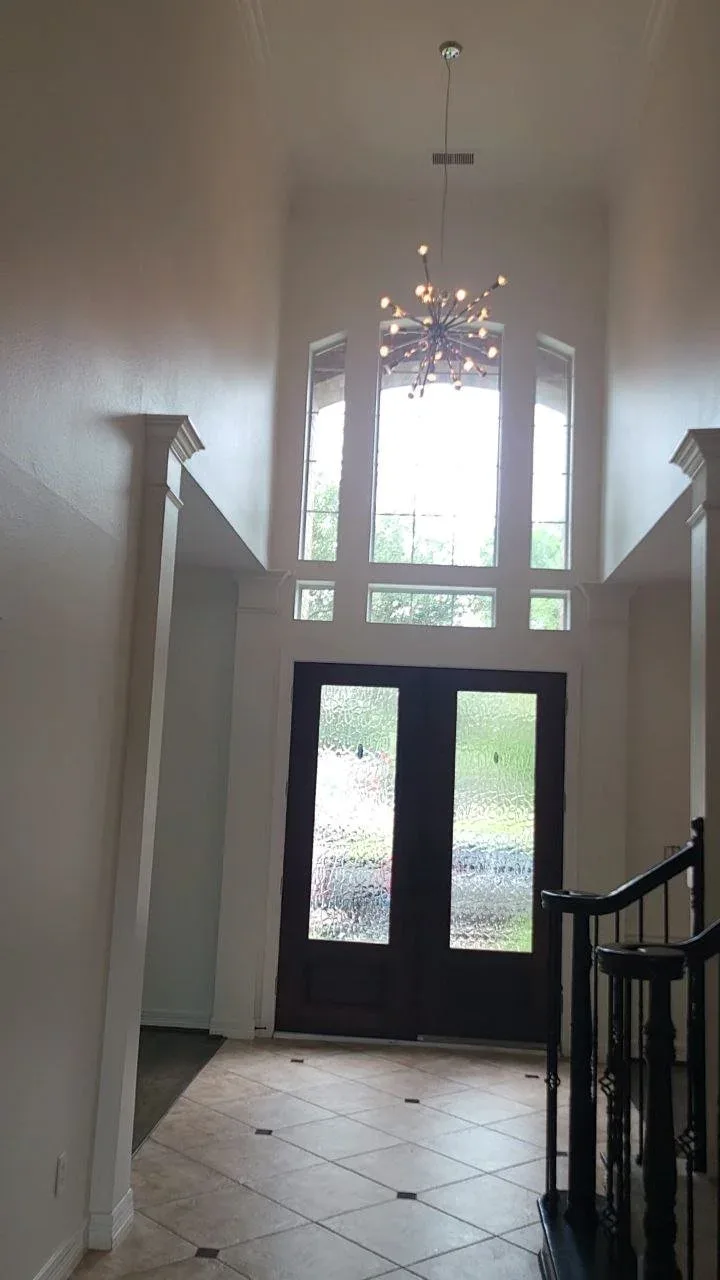 Two-story foyer interior repaint in Richmond, TX by The Proud Paintbrush