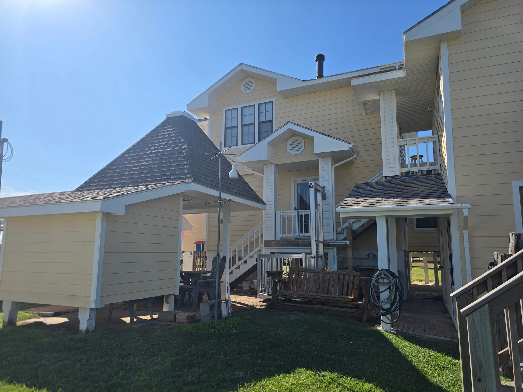 Yellow Home Exterior Deck Repaint in Katy, TX by The Proud Paintbrush